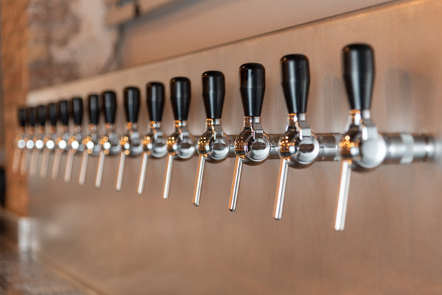 A long row of taps along the bar at the Maresme Brewery taproom